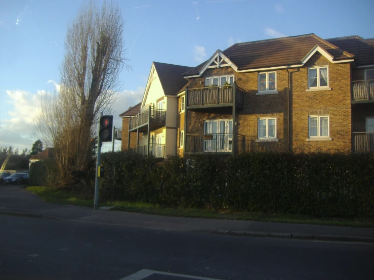 a row of houses with balconies on each windows and an overhang