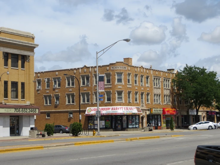 a city street corner with an older brick building in the background