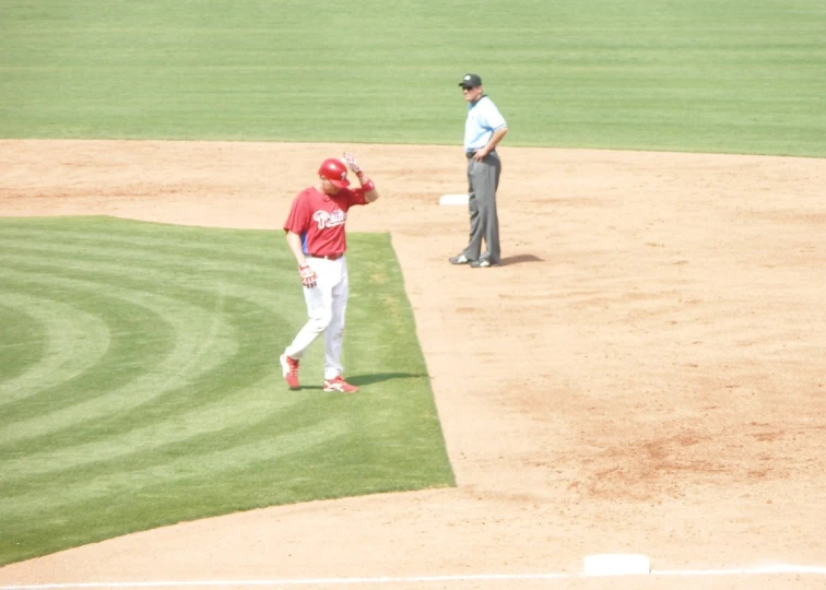 a baseball player and his coach at the pitchers mound