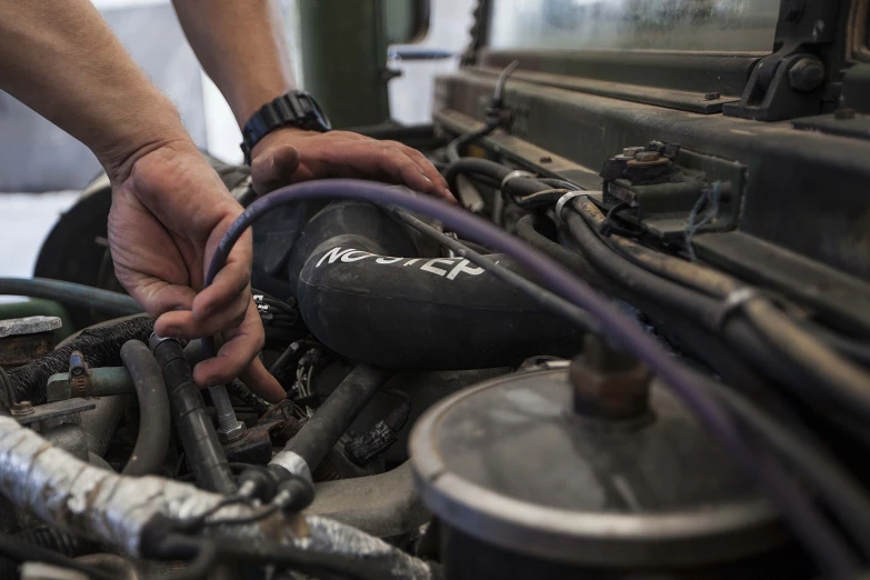 a man with his hands on the tank of a car