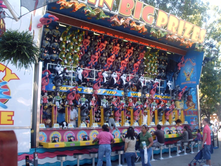 s standing in front of the fairground ride for toys