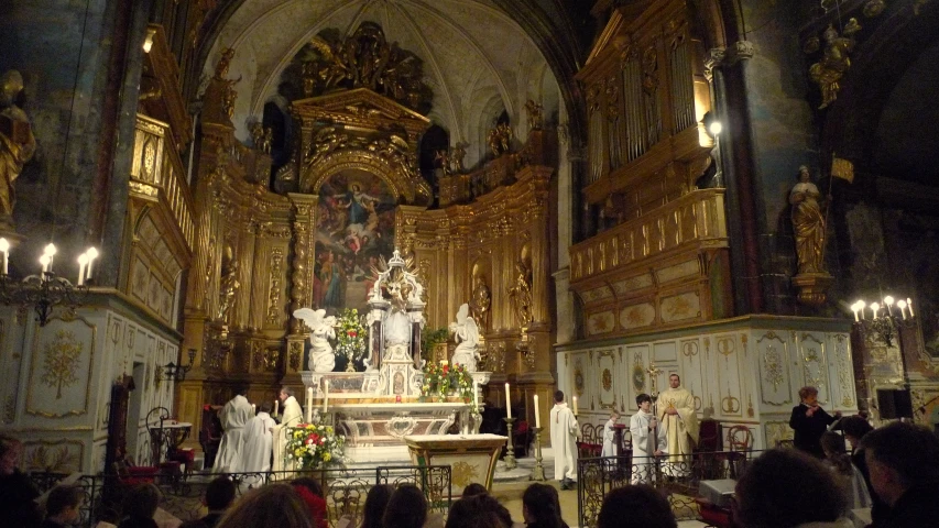 large cathedral with altar and religious people in it