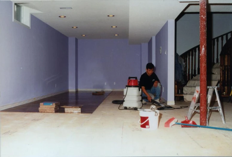 the man is painting a room purple