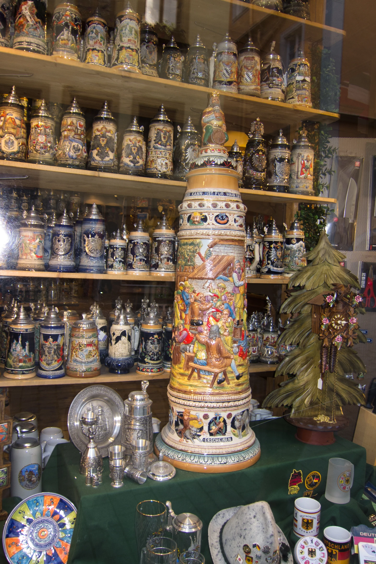 a bunch of glass dishes on display behind a glass window