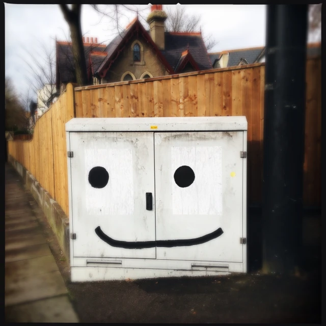 an outdoor po with a large white box painted to look like a face