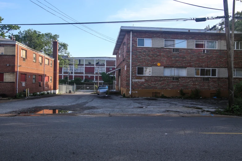 some red brick buildings on the side of a street