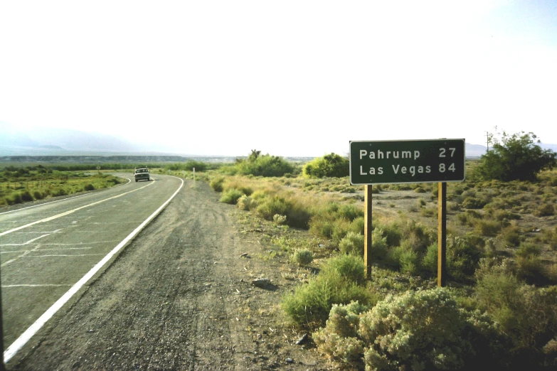 a road in the middle of nowhere with a large sign