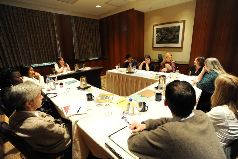 a large group of people sitting around a table