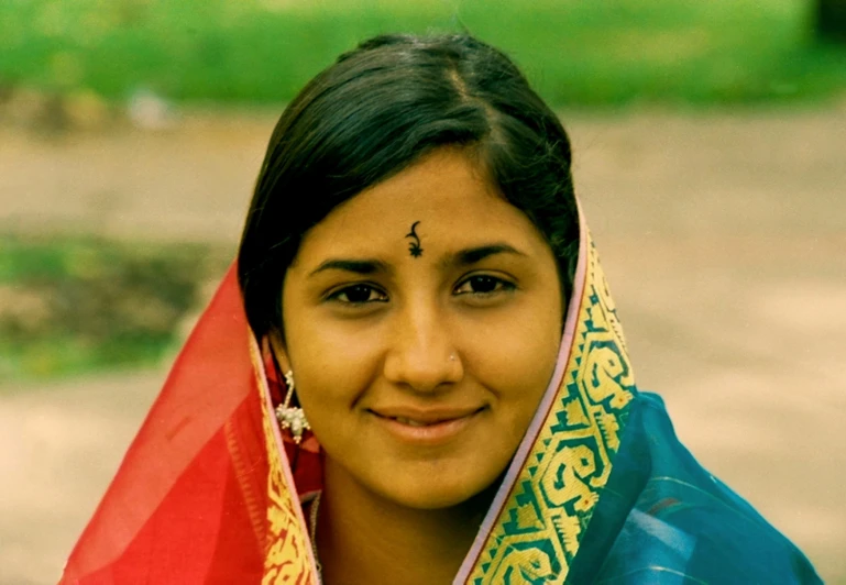 a woman with a colorful blanket around her neck