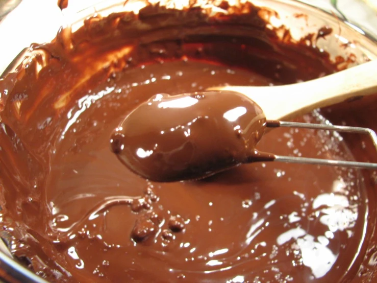 chocolate icing and chocolate covered spoon on table