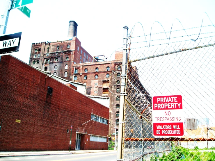 the buildings behind the metal fence are brick and brick