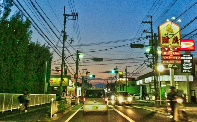 city bus driving on a street with traffic lights at night