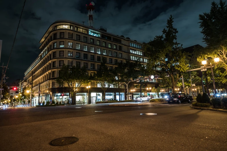 a night scene shows buildings along the street