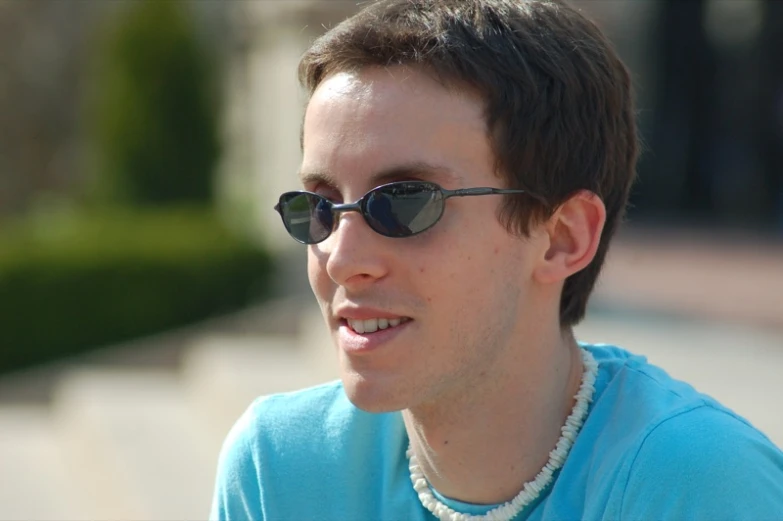 a man wearing some beads in his necklace