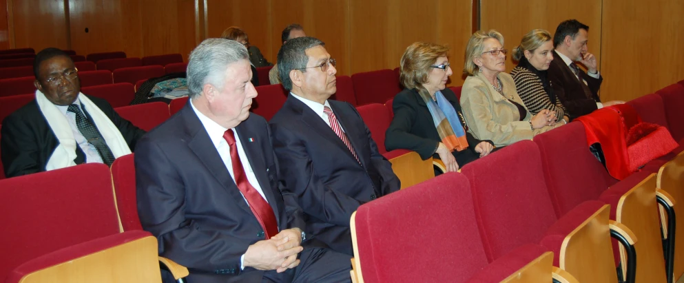 a group of people sit in a lecture hall