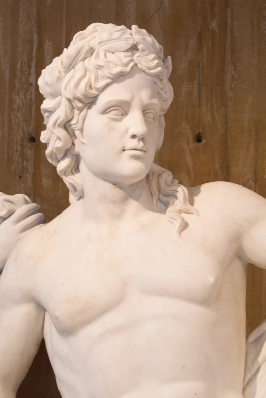 a statue is showing muscles for a man