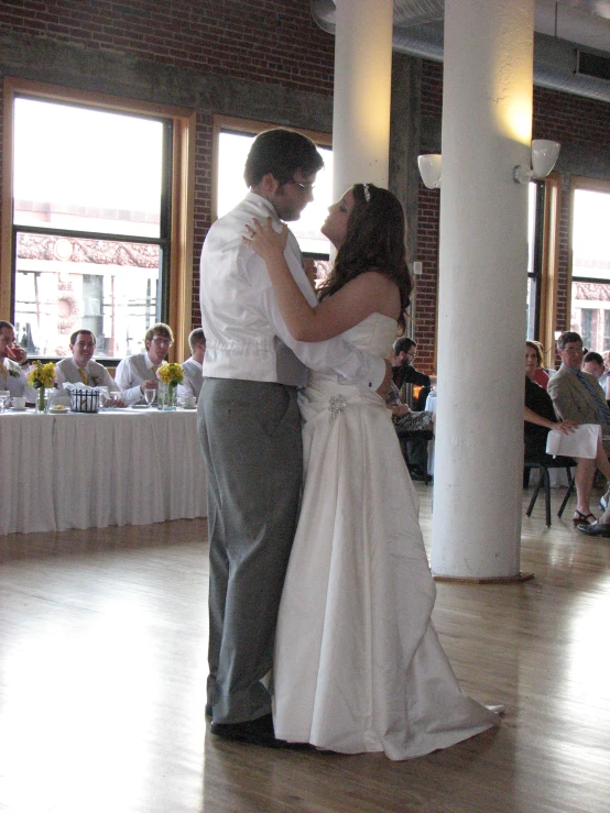 two people are dancing together at a wedding