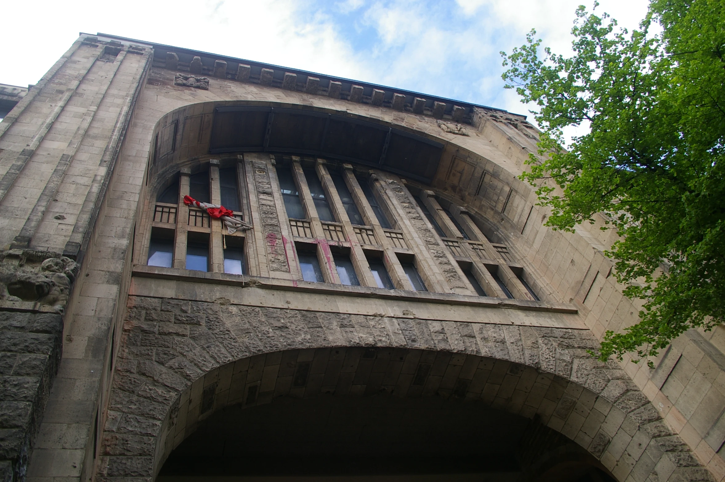 an arched door to an old building that has several windows