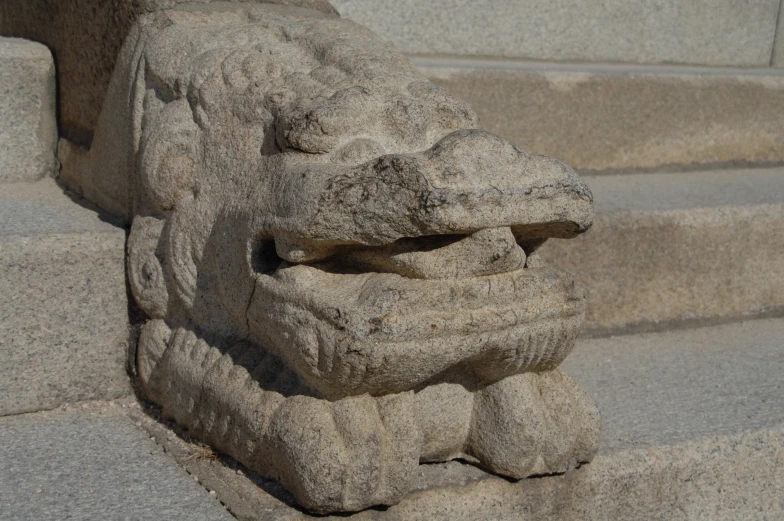 stone carved faces are next to the steps