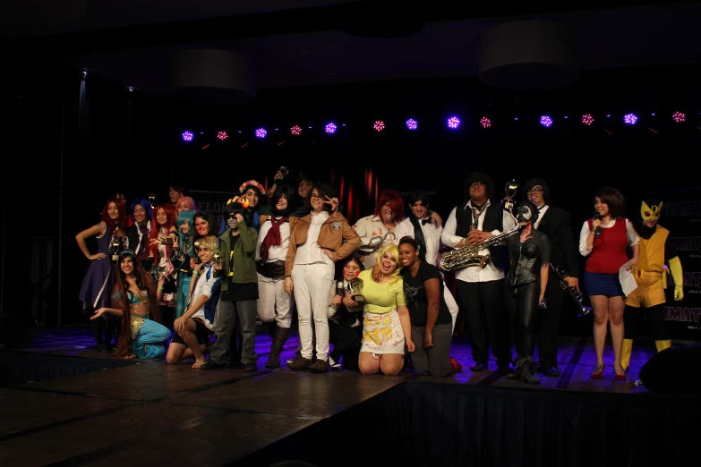 a group of people in costume standing on a stage