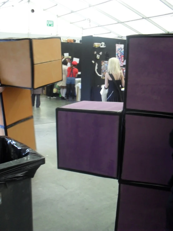 the interior of a shopping area with various booths on display