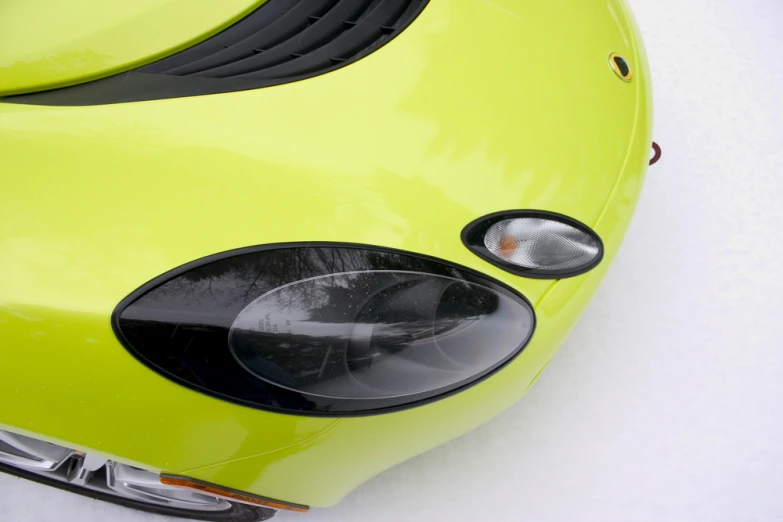 the front end of a yellow sports car