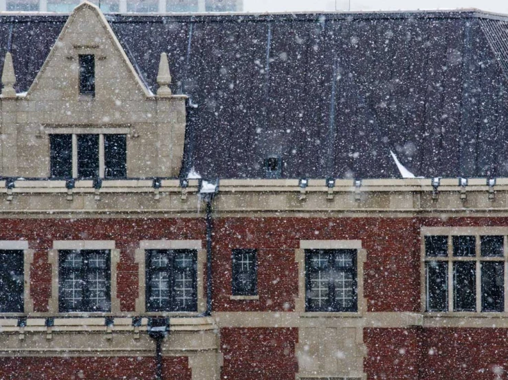 snowy weather outside of a building in an old neighborhood