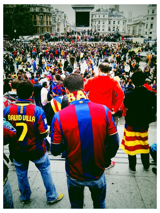 a crowd of people standing around each other at a sports game