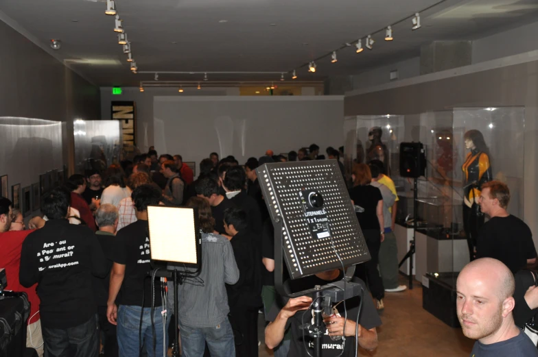 a large group of people in a room with a sign