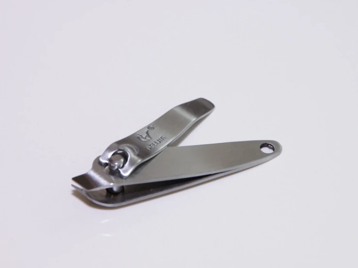 an angled silver clip holder sits on a white table