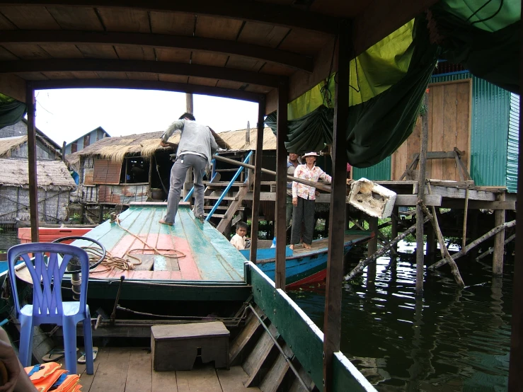 people and a boat in the water on a lake