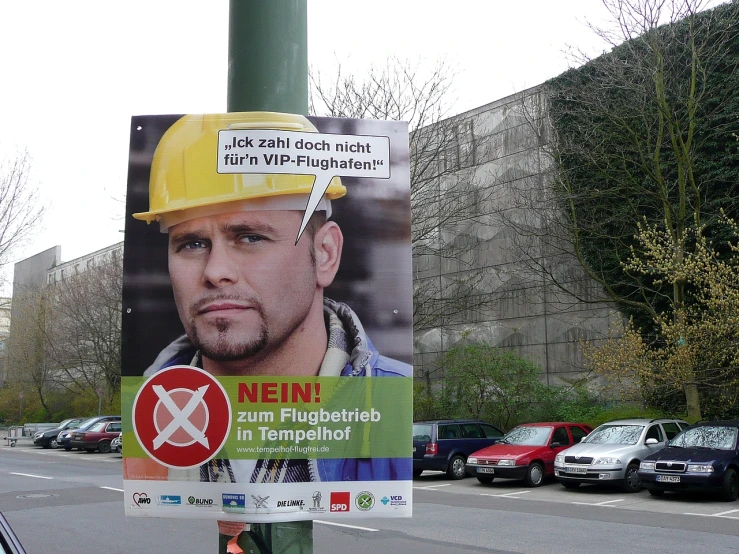 an image of a political poster with a hard hat on it