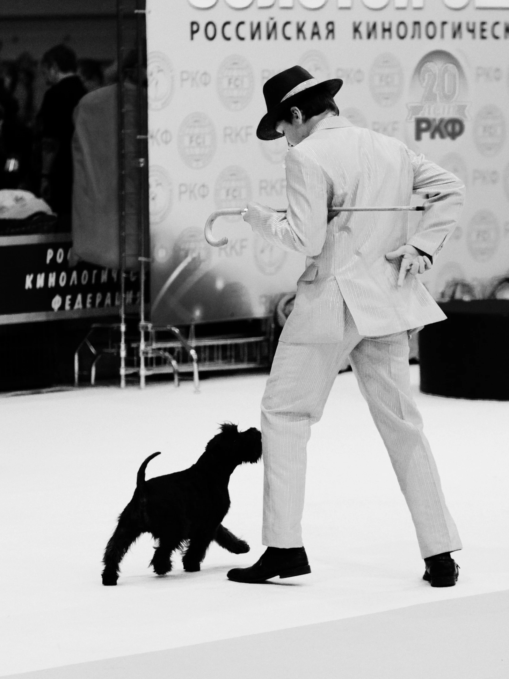 a man in a suit with his dog at an awards event