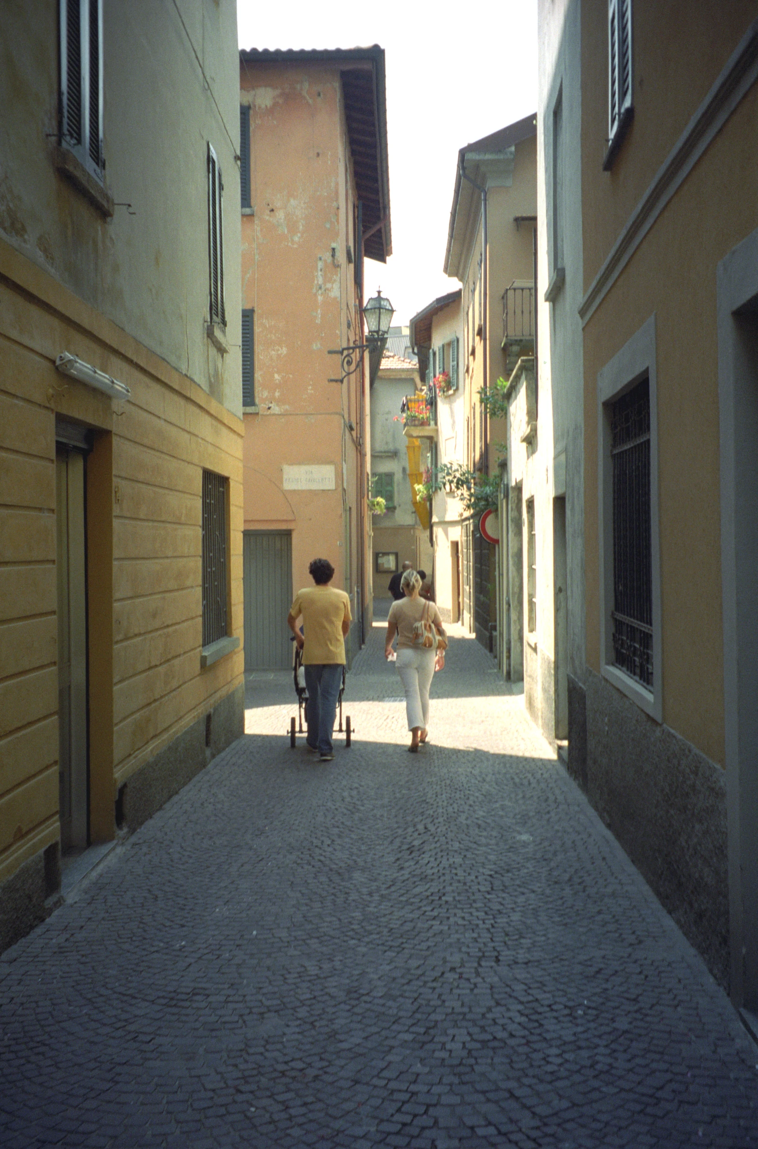 a person hing someone behind in a small cart