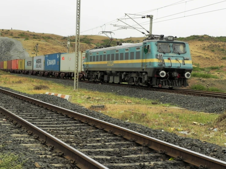 a train riding along a track next to trees and bushes