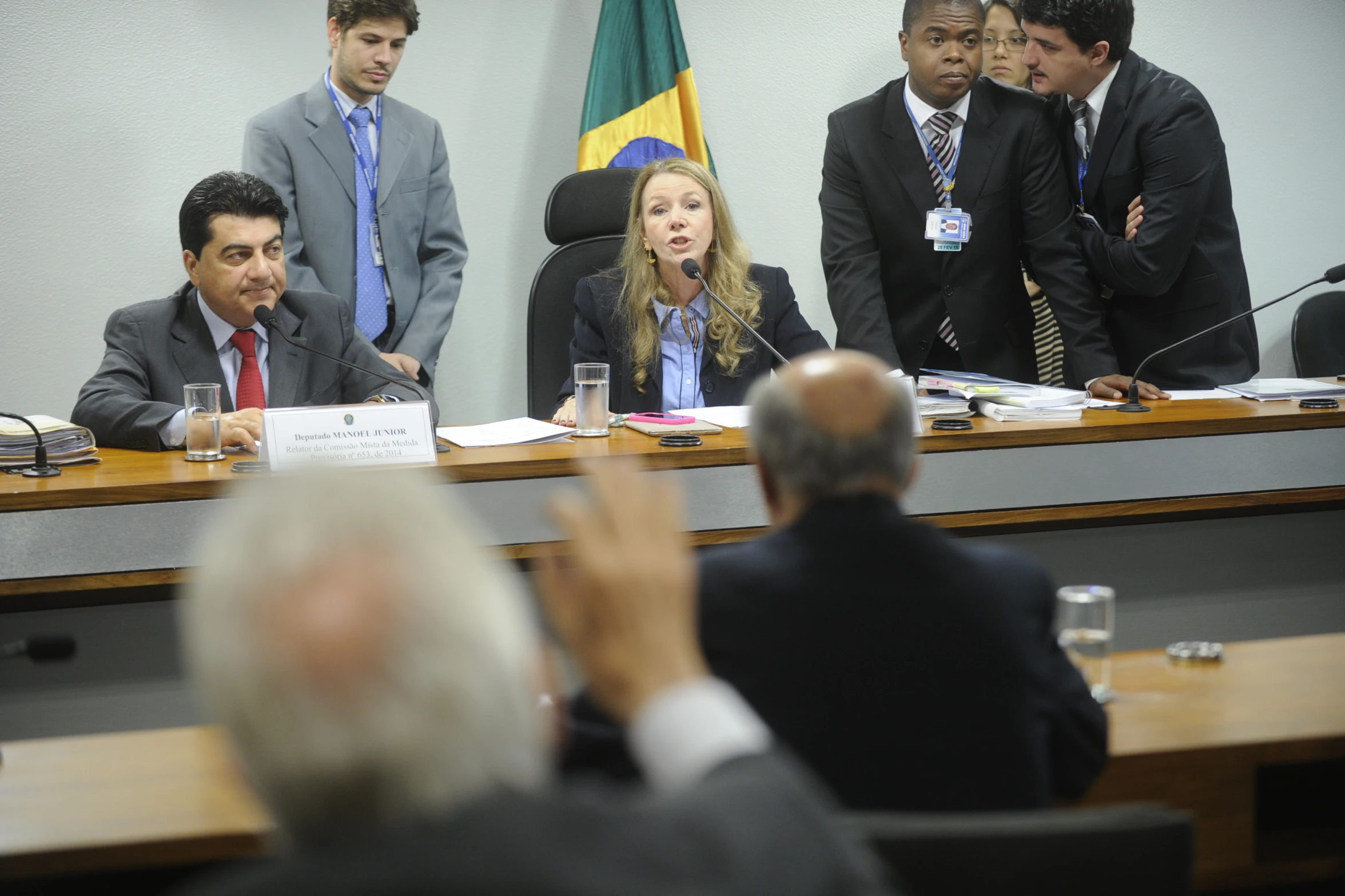 several people sitting at a table in front of them