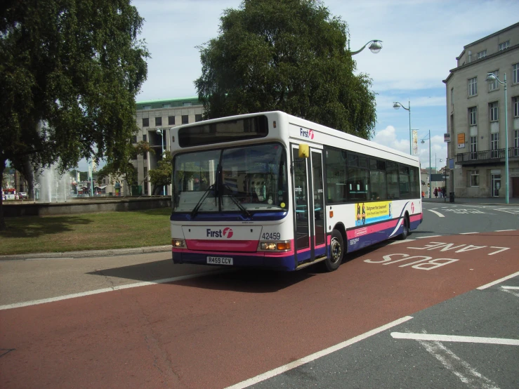 the city bus is traveling down the street