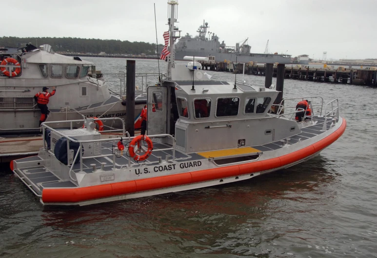 small tug boat tied to the pier