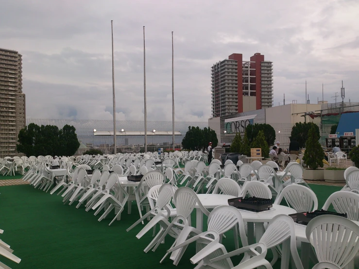 the white tables and chairs are arranged together