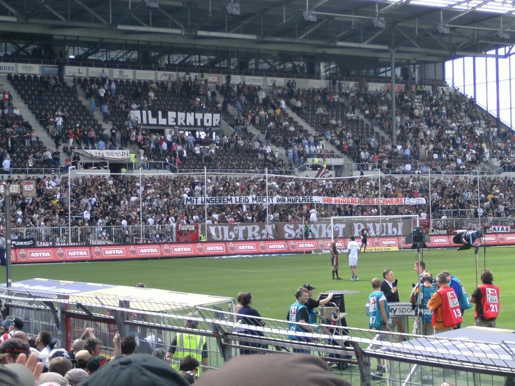 a crowd of people are watching a soccer game