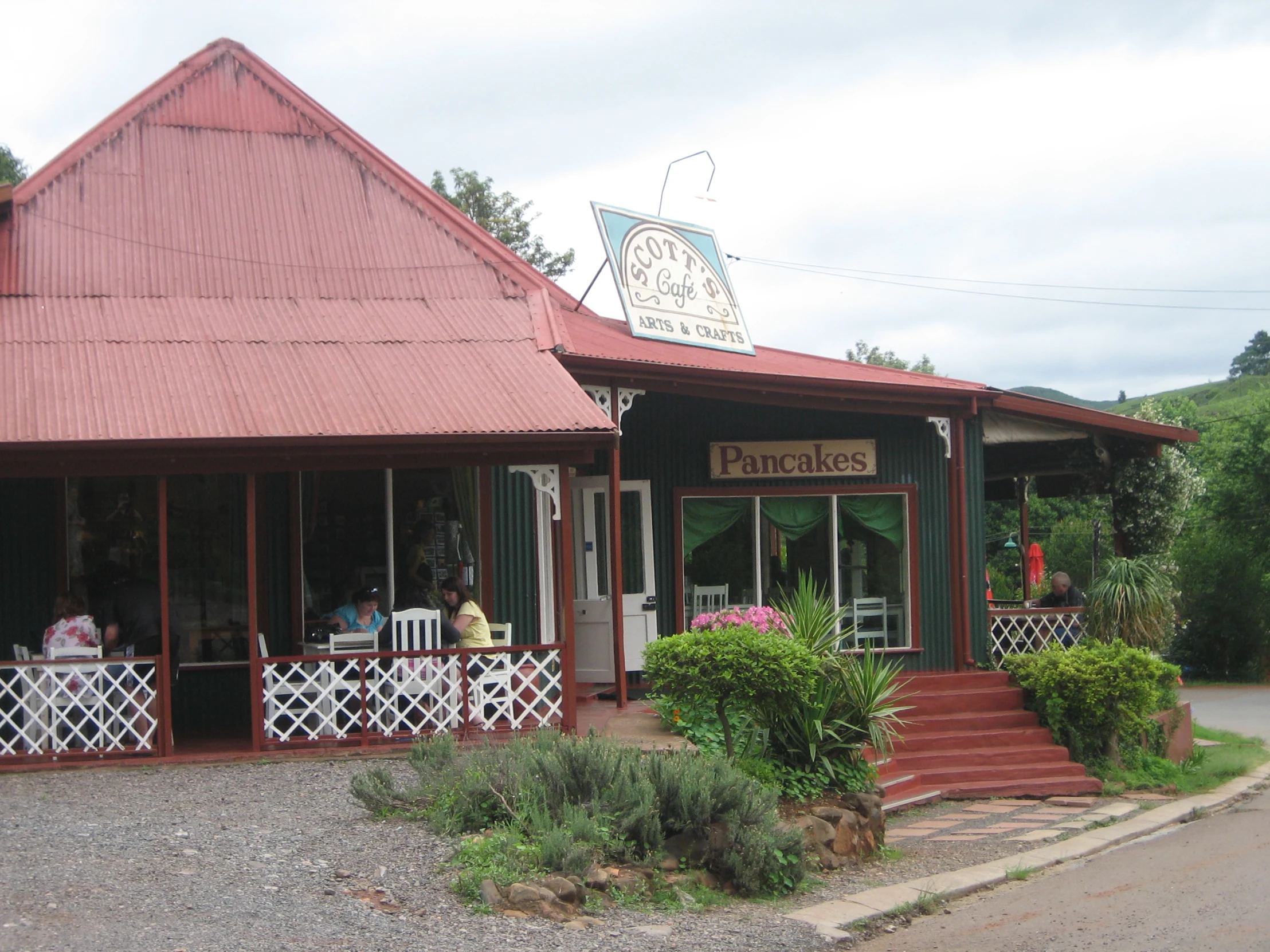 a small store is on the side of a street