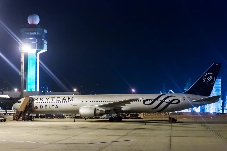 an airliner is parked in an airport at night