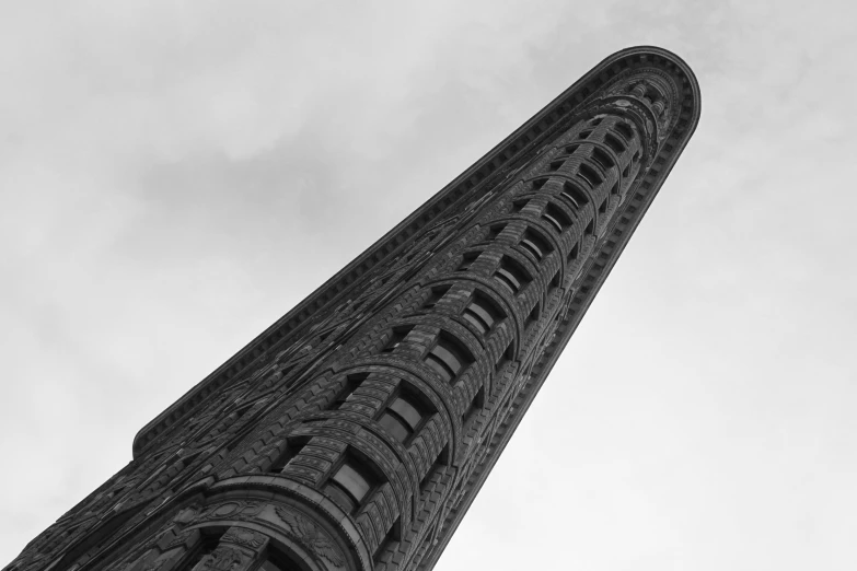 the top of a tall building against a cloudy sky