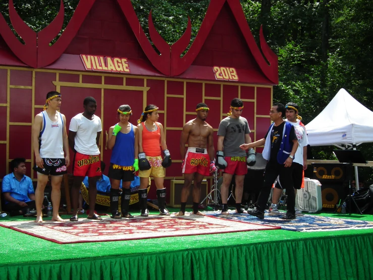 a group of people standing on a stage with shorts