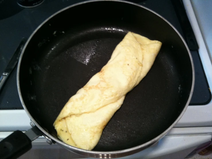a omelette sitting in a frying pan on a stove