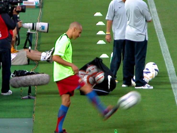 soccer players are on the field with bags and gear