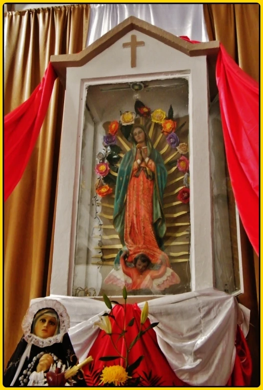 a picture of the virgin mary on display on a table