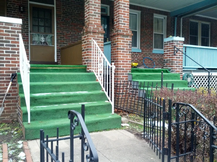 the stairs have green steps leading up to the house