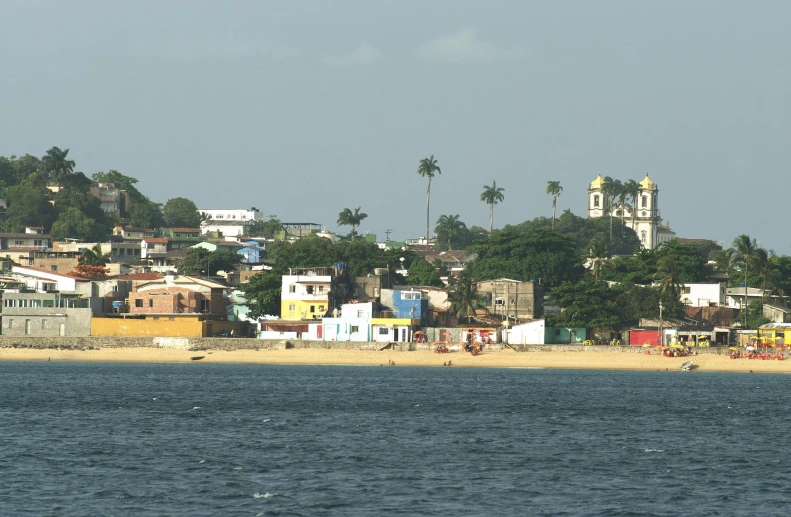 there is a colorful beach and city along side the ocean