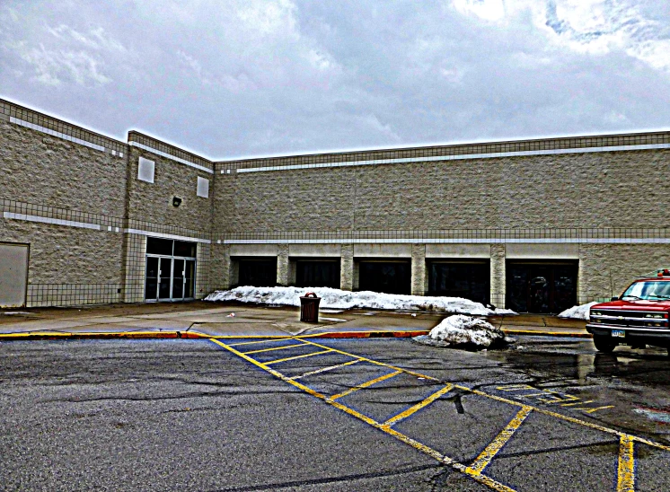 the building is empty with a car in the parking lot